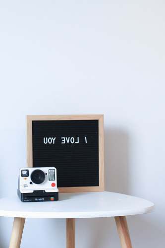 electronics white and black Polaroid instant camera camera